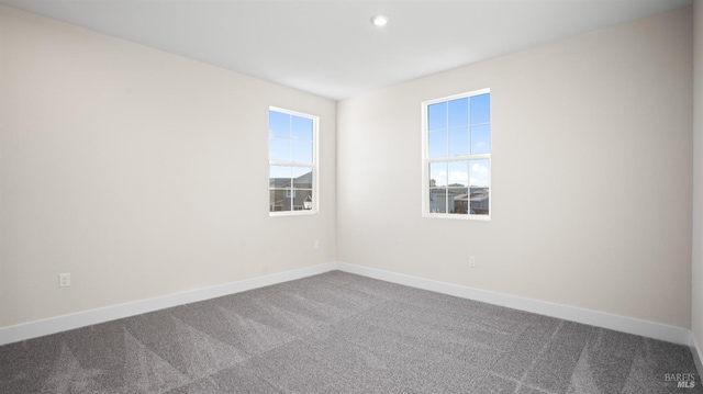 carpeted empty room featuring plenty of natural light