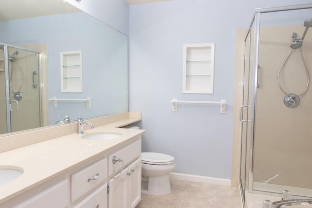 bathroom featuring walk in shower, vanity, tile patterned floors, and toilet