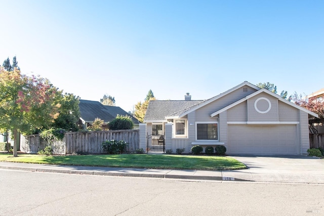 view of front of house featuring a garage and a front lawn