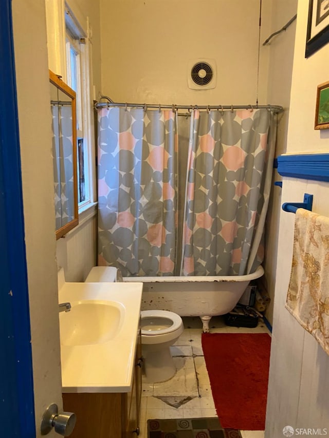 full bathroom with tile patterned floors, vanity, toilet, and shower / bath combo