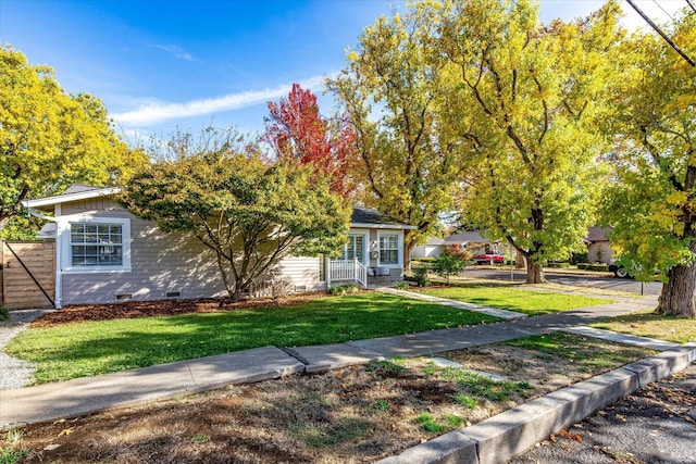 obstructed view of property with crawl space and a front lawn