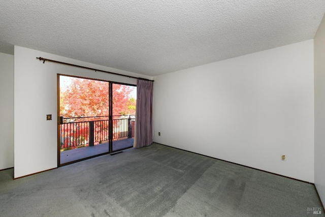 spare room featuring a textured ceiling, carpet floors, and visible vents