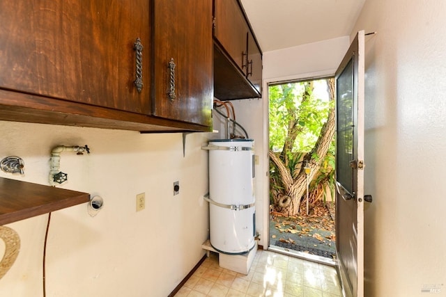 washroom featuring cabinet space, secured water heater, and hookup for an electric dryer