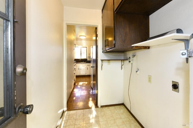 interior space with dark brown cabinetry and baseboards