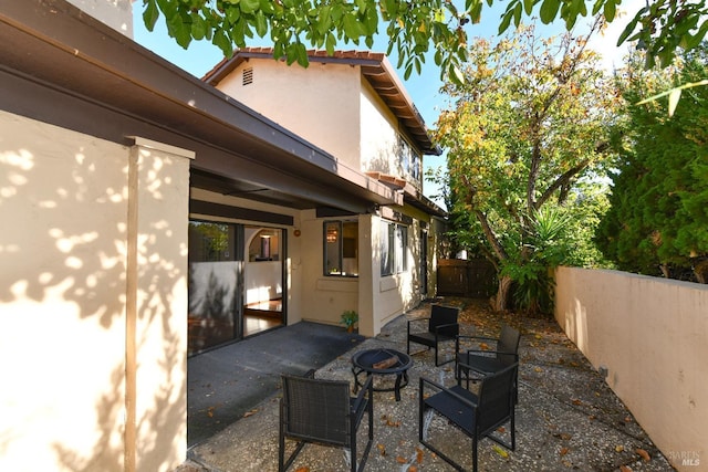 view of patio with a fenced backyard and a fire pit