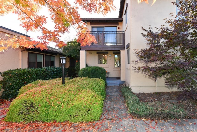 view of front of property with a balcony and stucco siding