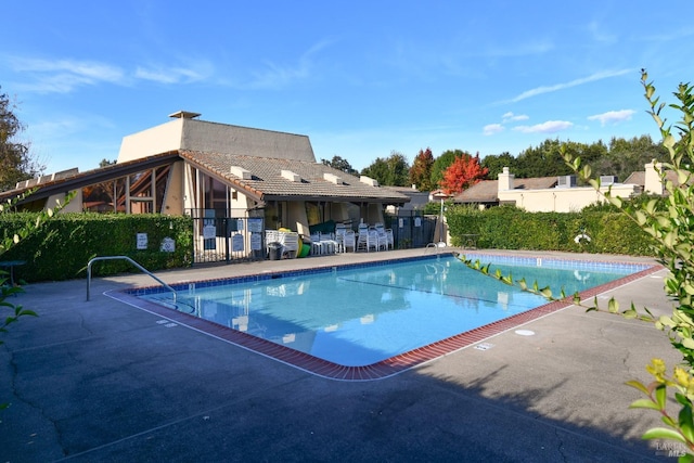 pool featuring a patio and fence