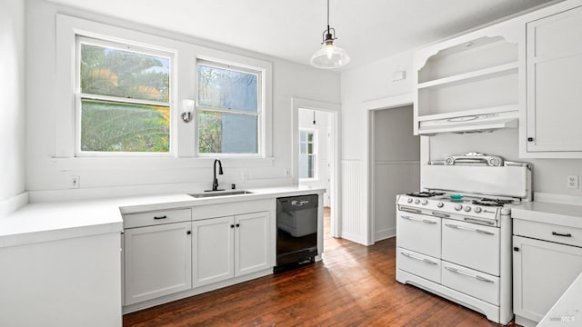 kitchen featuring dishwasher, white gas range oven, sink, decorative light fixtures, and dark hardwood / wood-style flooring