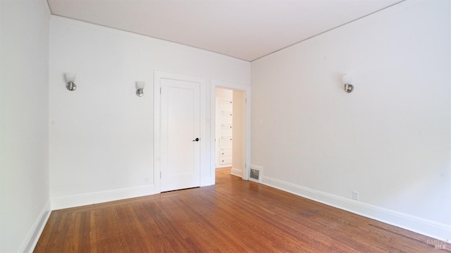 spare room with wood-type flooring