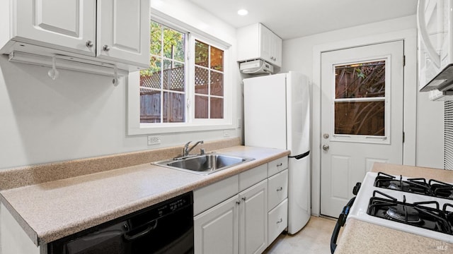 kitchen featuring white cabinetry, sink, and white appliances