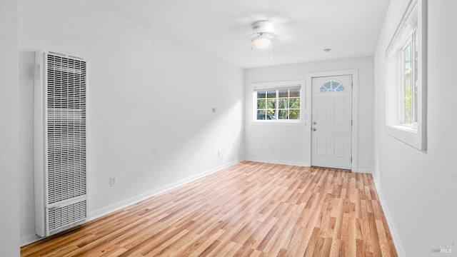 foyer entrance with ceiling fan and light hardwood / wood-style floors