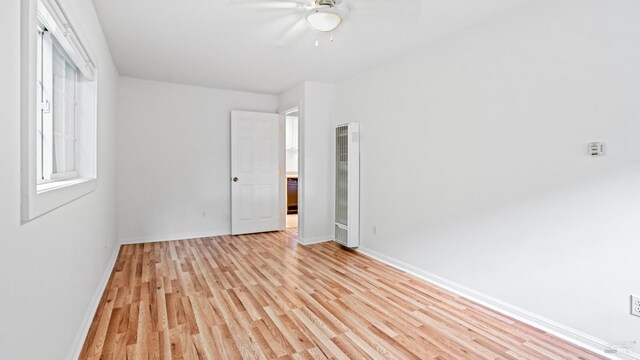 unfurnished room featuring ceiling fan and light wood-type flooring