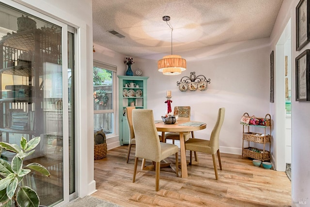 20 Meadowgreen Cir, Santa Rosa, CA 95409 - dining room with wood finished floors, a textured ceiling, and baseboards