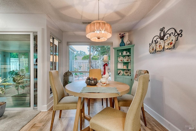 20 Meadowgreen Cir, Santa Rosa, CA 95409 - dining area featuring a textured ceiling, light wood finished floors, and baseboards