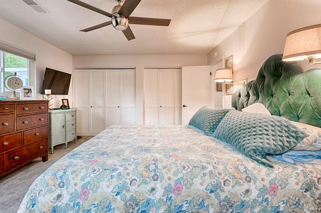 20 Meadowgreen Cir, Santa Rosa, CA 95409 - bedroom with multiple closets, light colored carpet, a textured ceiling, and ceiling fan
