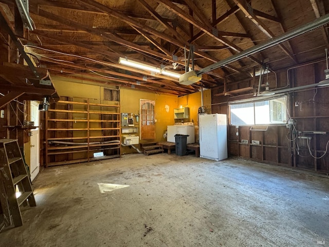 garage with white refrigerator and washer / clothes dryer