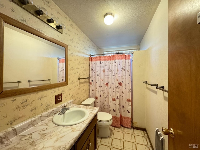 bathroom with vanity, toilet, a shower with shower curtain, and a textured ceiling