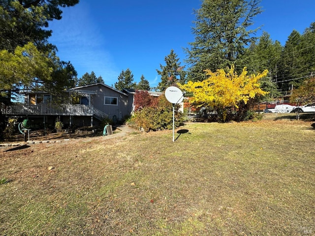 view of yard with a wooden deck