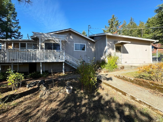 back of house with a wooden deck