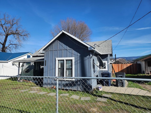 view of side of home featuring a lawn