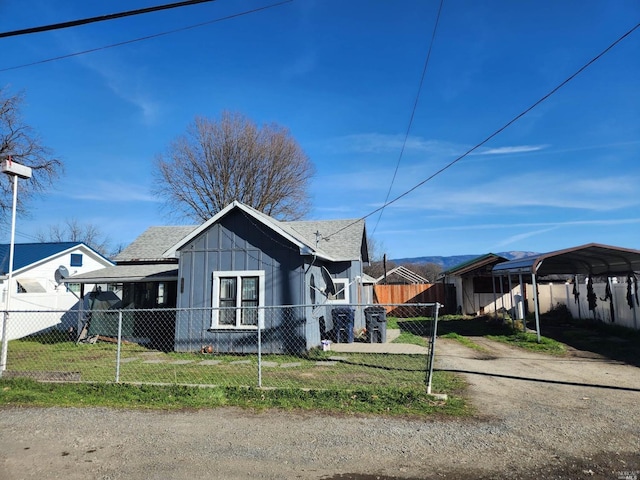 view of home's exterior with a yard and a carport