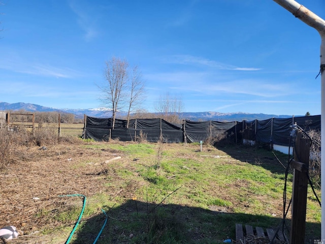 view of yard with a mountain view and a rural view