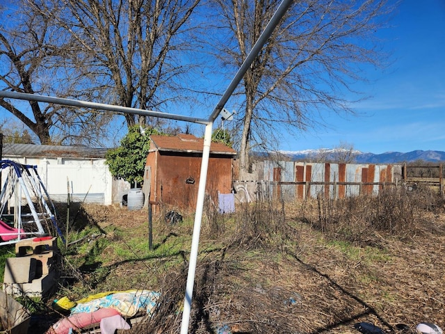 view of yard with a mountain view and a storage unit