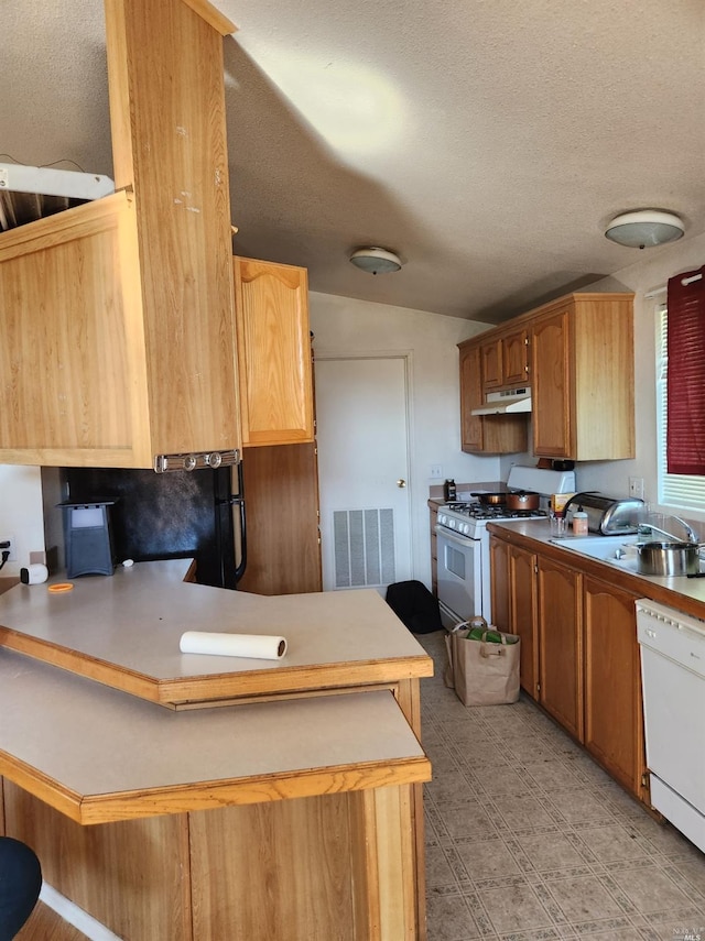 76319 Lovell St, Covelo, CA 95428 - kitchen featuring white appliances, a peninsula, vaulted ceiling, under cabinet range hood, and a breakfast bar