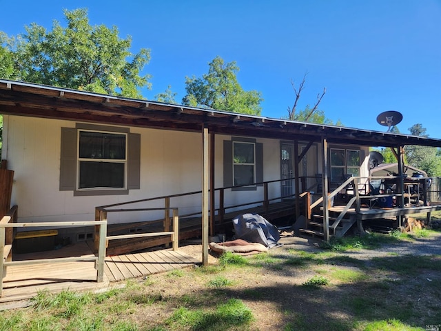 rear view of house featuring a deck