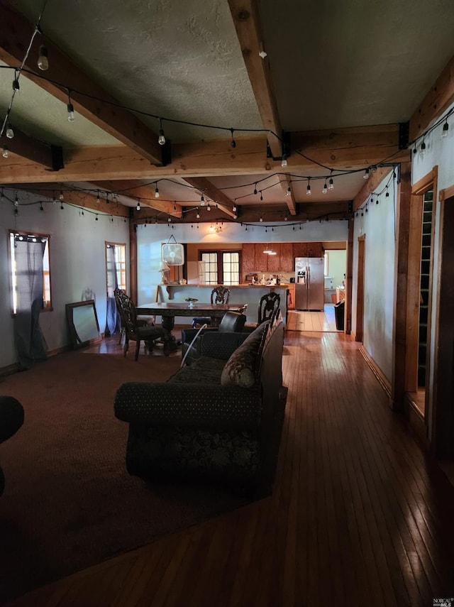 living room with beamed ceiling and hardwood / wood-style flooring