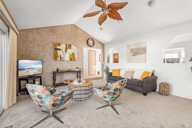 carpeted living room featuring ceiling fan and vaulted ceiling