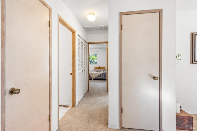 hallway with light colored carpet