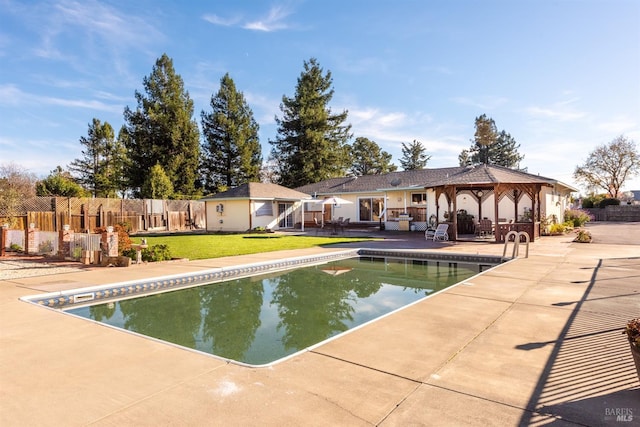 view of swimming pool featuring a patio area, a gazebo, and a yard