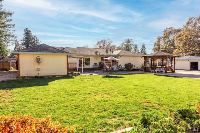 rear view of property featuring a patio, a gazebo, and a lawn