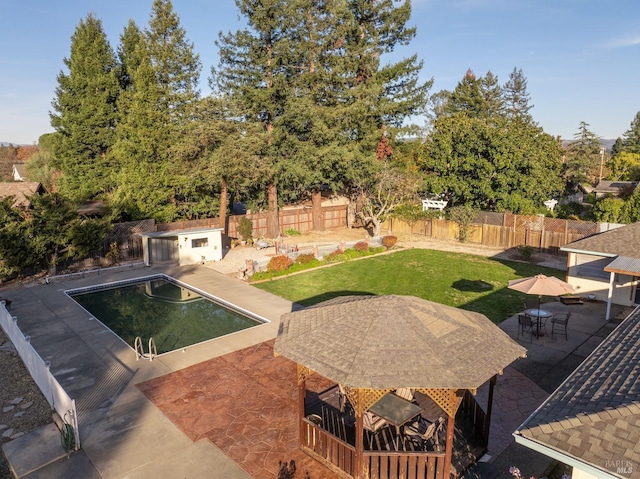 view of pool featuring a patio area and a yard