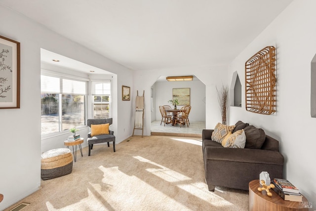 sitting room featuring light carpet