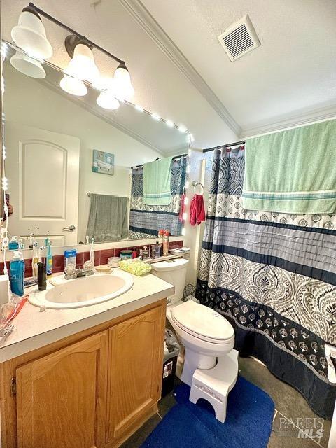 bathroom featuring toilet, vanity, ornamental molding, and curtained shower