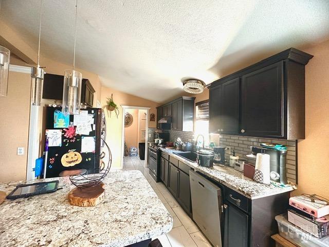 kitchen with decorative backsplash, a textured ceiling, sink, appliances with stainless steel finishes, and decorative light fixtures