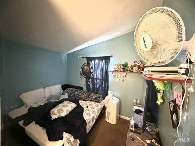 carpeted bedroom featuring vaulted ceiling