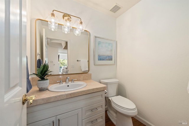 bathroom with vanity and toilet