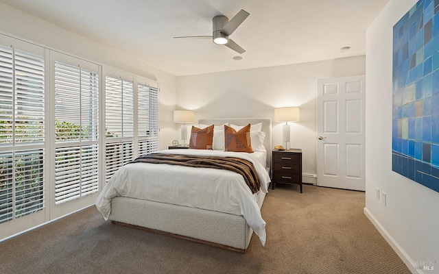 carpeted bedroom featuring ceiling fan and baseboard heating