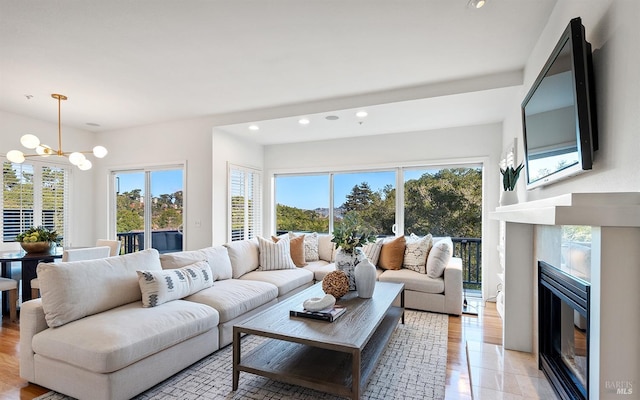 living room featuring a wealth of natural light and a notable chandelier