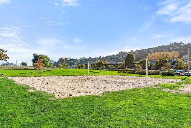 surrounding community featuring a yard and volleyball court