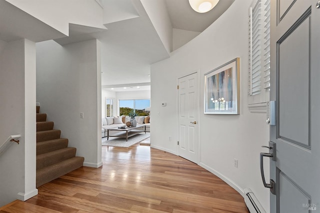 entrance foyer with baseboard heating and light hardwood / wood-style flooring