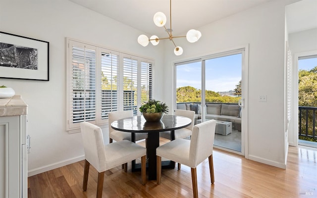 dining area featuring a chandelier, light hardwood / wood-style flooring, and a wealth of natural light