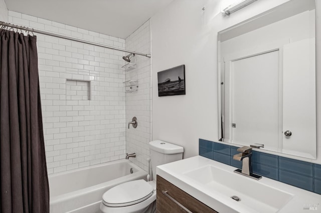 full bathroom featuring shower / bath combo with shower curtain, vanity, and toilet