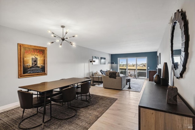 dining area featuring a chandelier and light wood-type flooring