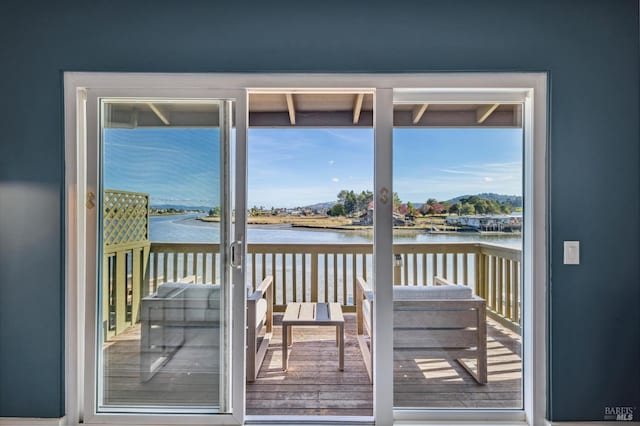 doorway to outside featuring a wealth of natural light and a water view