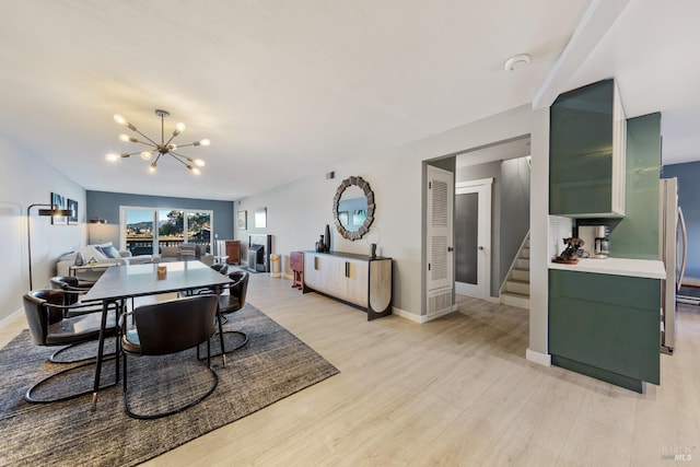 dining area featuring light hardwood / wood-style floors and a notable chandelier