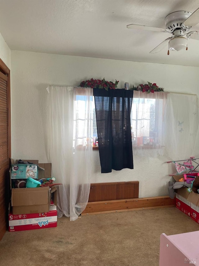 carpeted bedroom with ceiling fan